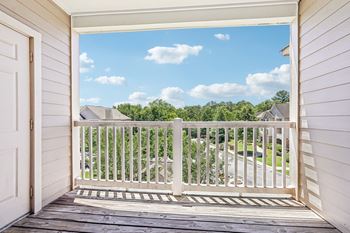 A view from a porch looking out at a residential neighborhood.